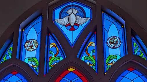 Stained glass with a dove, Alpha, and Omega