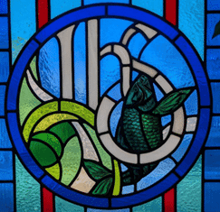 Stained glass with IHS and a fish