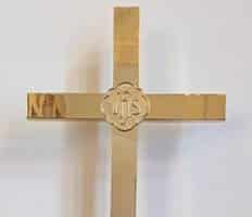 Brass wall cross with an IHS medallion