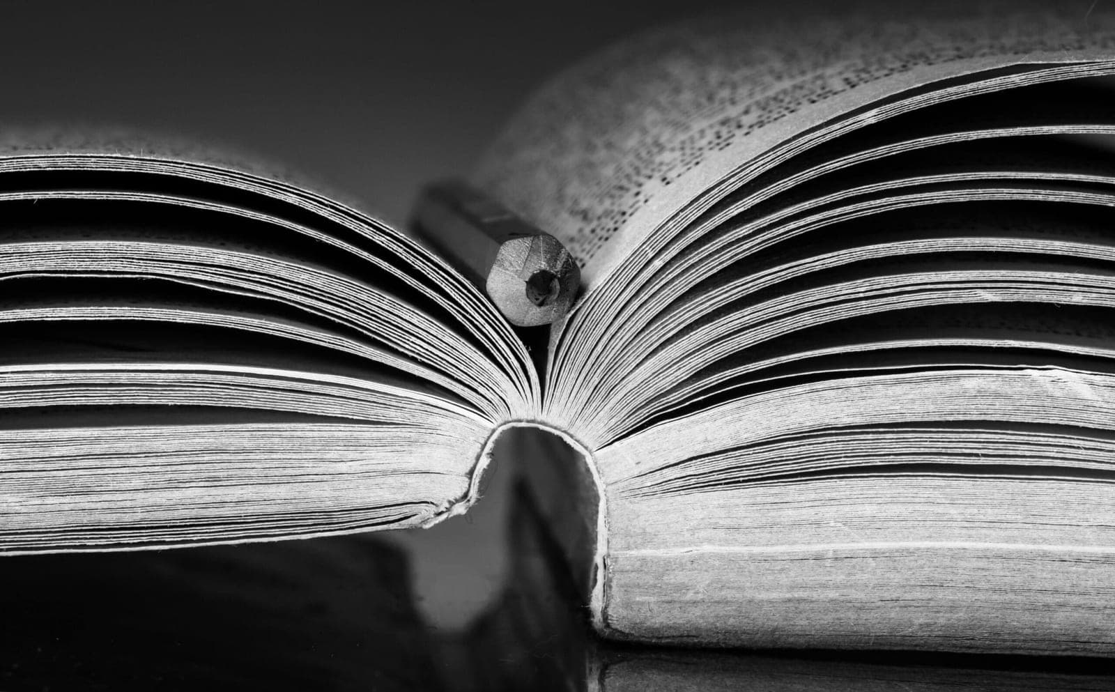 An open book with a pencil in the gutter, photographed in the church